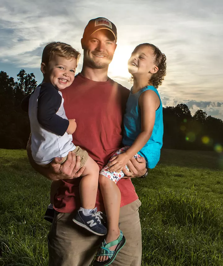 Proud father holding both of his children.