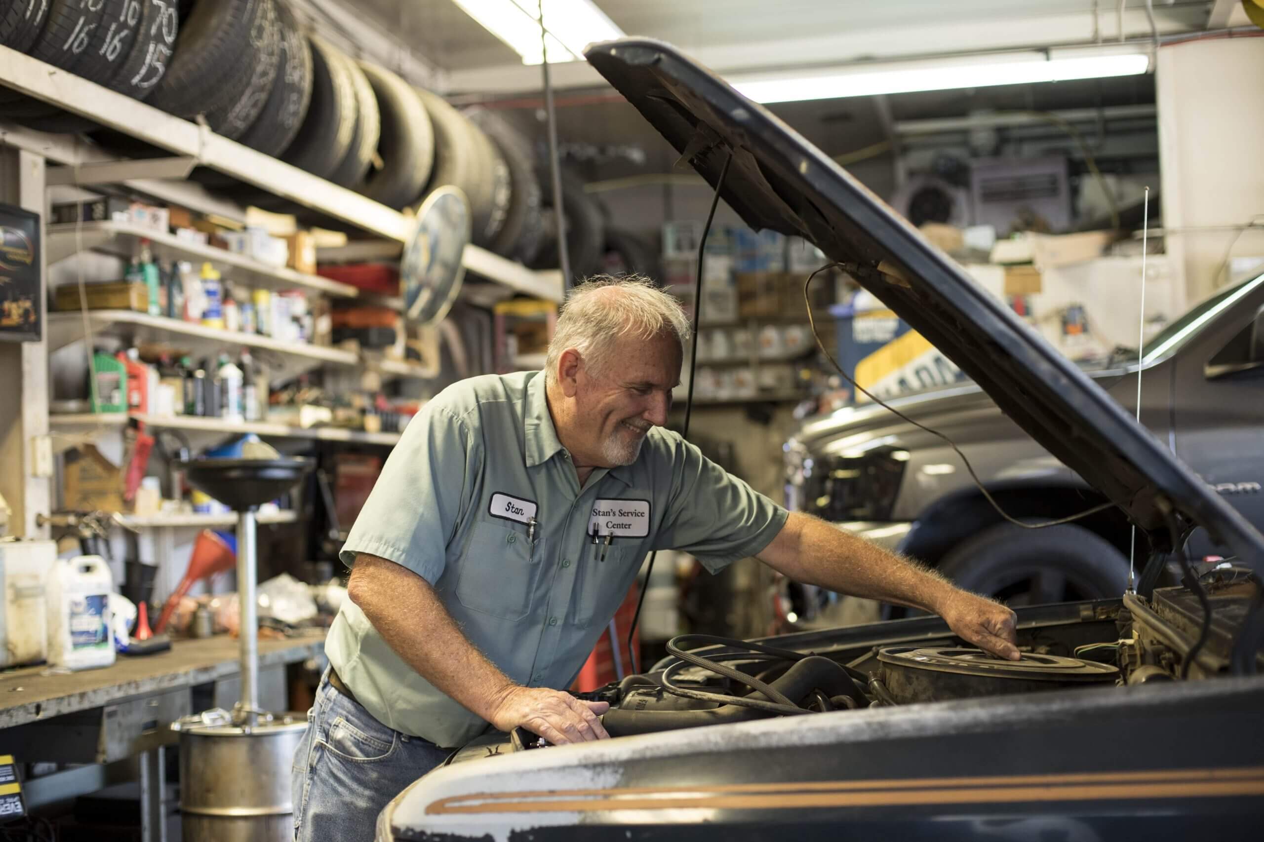 Mechanic fixing the engine of a car that needs unexpected work done.