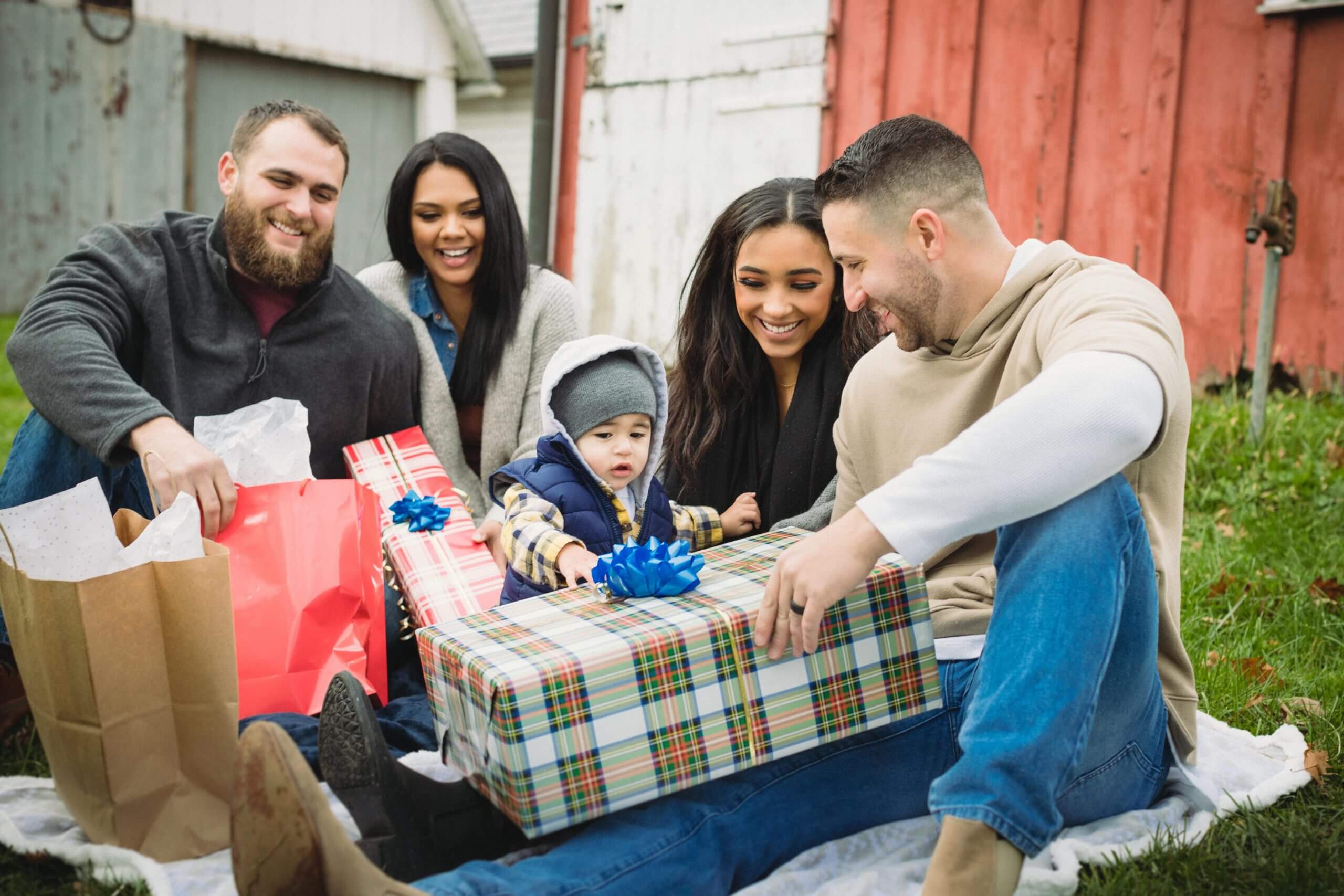 Happy family gathered together opening presents during the holidays.